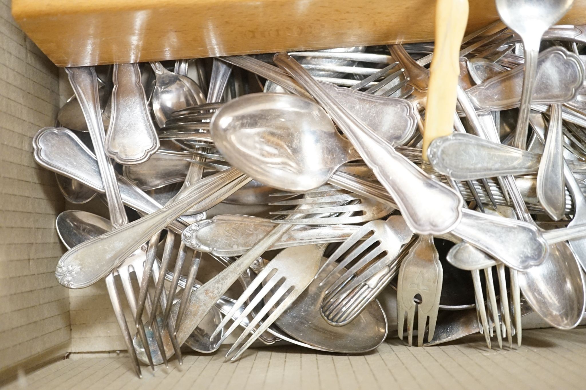 Small silver cutlery, together with a silver presentation coaster, a silver backed brush and various plated wares